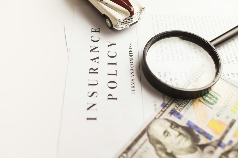 Travel insurance - Policy paper with a magnifying glass